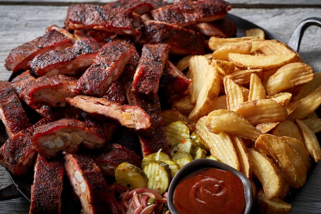 Southside Rib Tips with wedge fries, pickles and a ramekin of ketchup