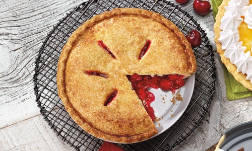 Cherry Pie topped with a sugared pie crust; a slice has been taken out