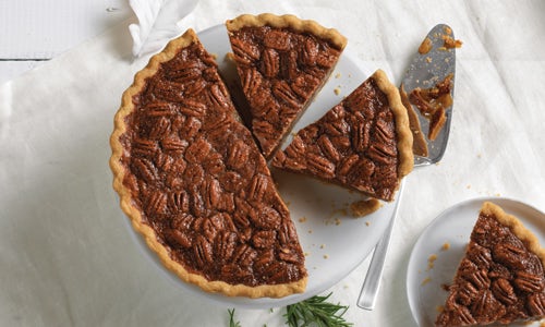 Southern Pecan Pie cut into slices on a white platter