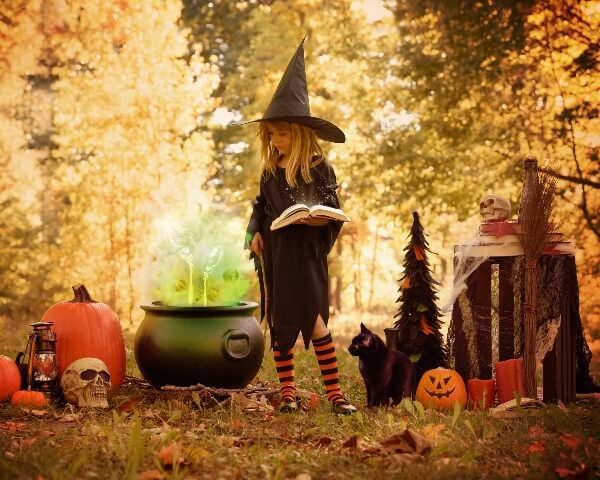 A child in a Halloween costume enjoys some trick or treating. 