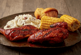 BBQ meat, potatoes, corn and cornbread muffin