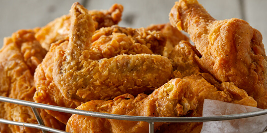 Image of a lot of pieces of Iris’ Down Home Fried Chicken in a basket