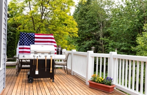 A U.S. flag stands proudly behind a BBQ grill ready for Memorial Day weekend.