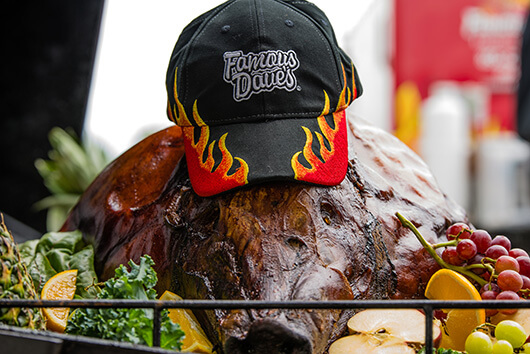 BBQed pig wearing a Famous Dave's BBQ hat
