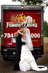 Wedding bride and groom in front of a Famous Dave's BBQ truck